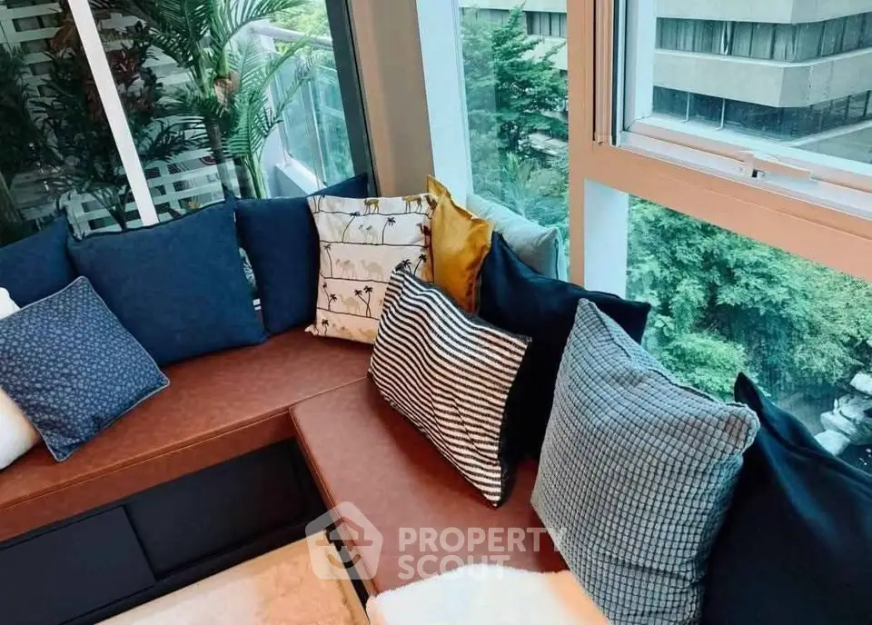 Cozy window seating area with plush cushions and lush greenery view, perfect for relaxation.