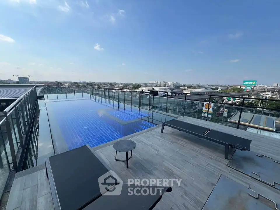 Stunning rooftop pool with panoramic city views and modern lounge area.