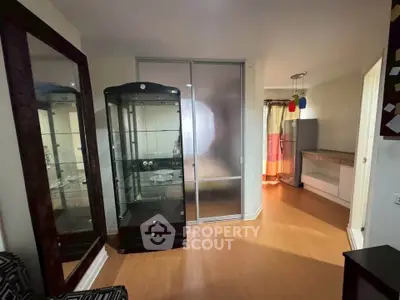 Spacious living area with modern glass cabinet and sliding doors