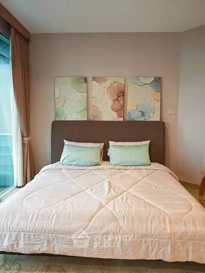 Cozy bedroom with elegant decor and large window for natural light