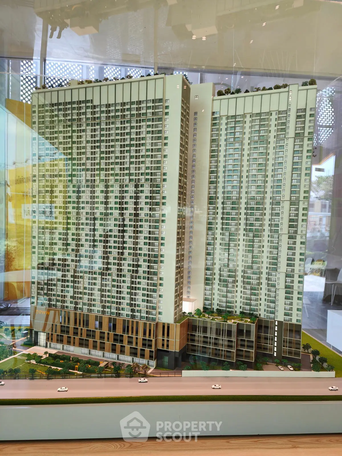 Stunning architectural model of a modern high-rise residential building with lush greenery.