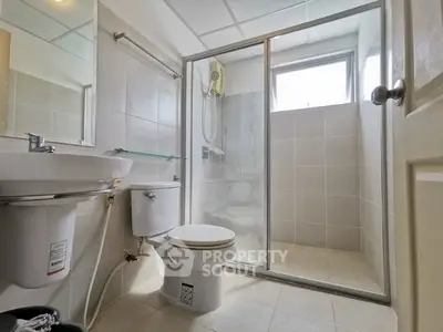 Modern bathroom with glass shower enclosure and sleek fixtures