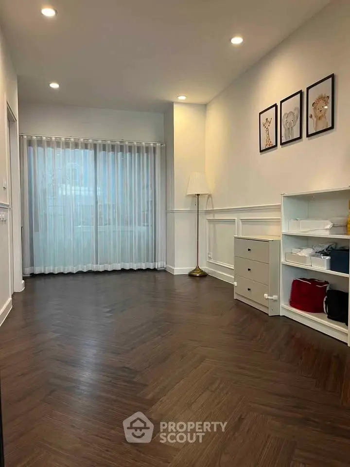Spacious modern living room with elegant wooden flooring and stylish decor.