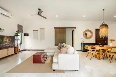 Spacious modern living room with stylish decor and open dining area, perfect for entertaining.