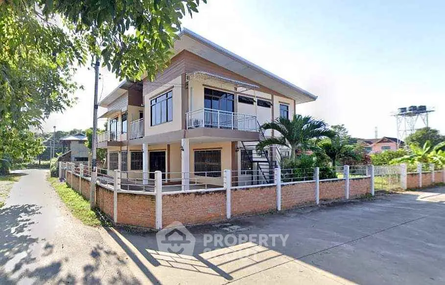 Charming two-story house with spacious balcony and lush garden in serene neighborhood.