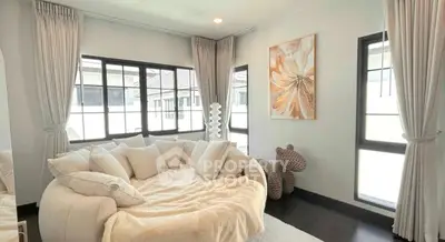 Bright and cozy living room with elegant decor and large windows.