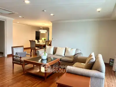 Spacious living room with elegant wooden flooring and cozy seating area