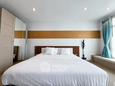 Spacious bedroom with modern decor and ample natural light