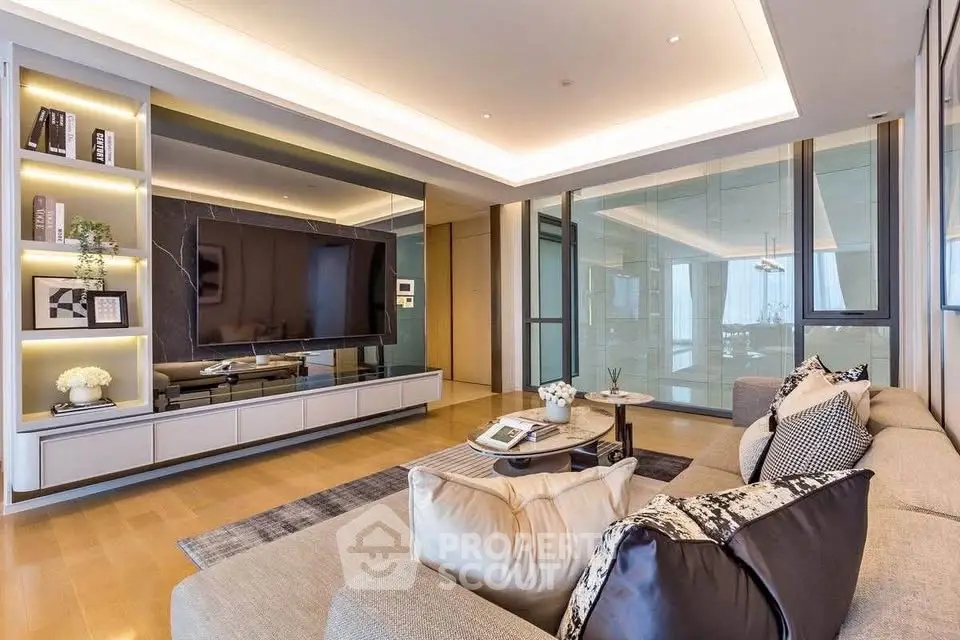 Luxurious modern living room with sleek design and large flat-screen TV, perfect for relaxation and entertainment.