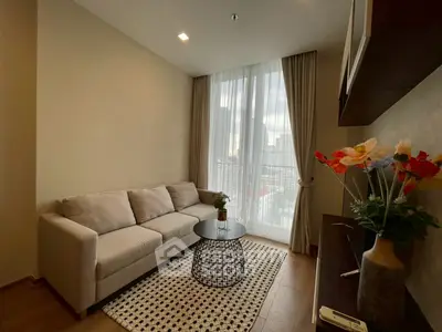 Cozy living room with modern decor and city view, featuring a comfortable sofa and stylish coffee table.