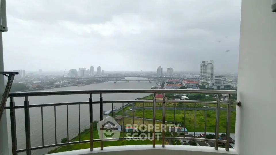 Stunning river view from high-rise balcony overlooking city skyline.