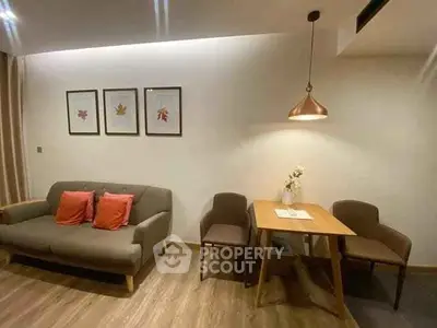 Cozy living room with modern decor and dining area, perfect for relaxation and entertaining.