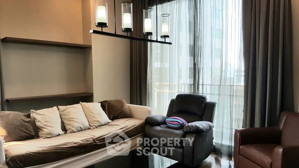 Modern living room with cozy seating and elegant lighting in a high-rise apartment.