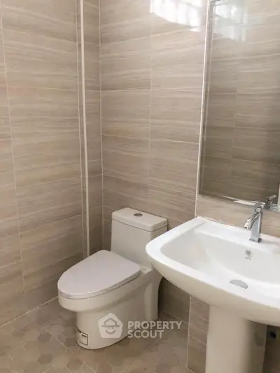 Modern bathroom with sleek fixtures and neutral tile design