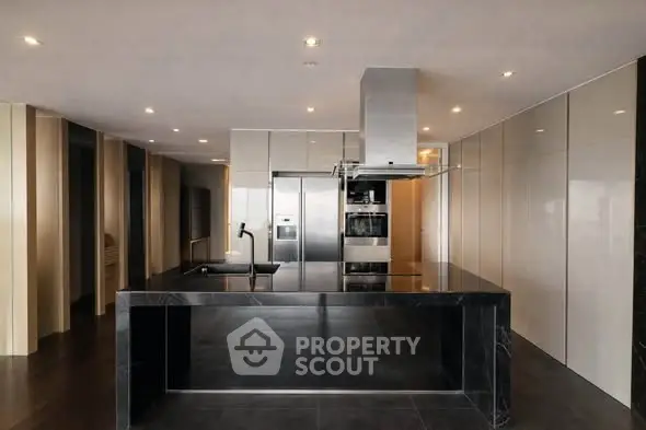 Luxurious modern kitchen with sleek black island and high-end appliances