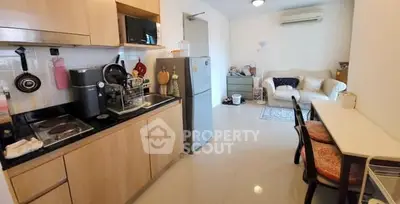 Cozy open-layout kitchen and living room with modern appliances and stylish decor.