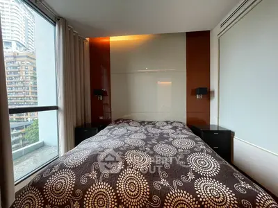 Modern bedroom with large window and stylish decor in urban apartment