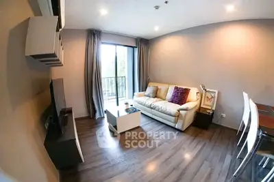 Modern living room with cozy sofa and balcony view in stylish apartment