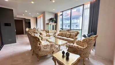 Luxurious living room with elegant furniture and large windows offering city views