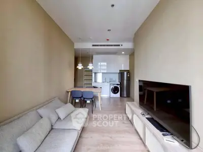 Modern living room with open kitchen and stylish furniture in a cozy apartment.