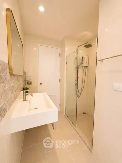 Modern bathroom with sleek shower and elegant sink in a stylish apartment.