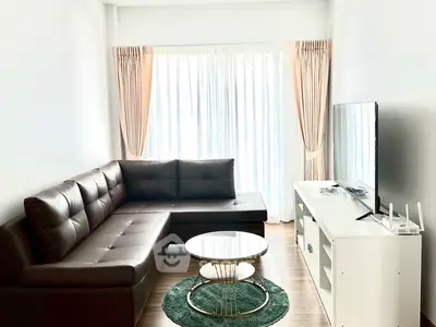 Modern living room with sleek brown sofa and large window