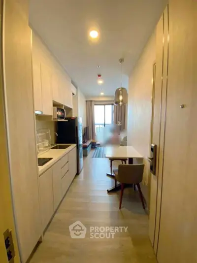 Modern open-layout kitchen and dining area with sleek design and natural light.