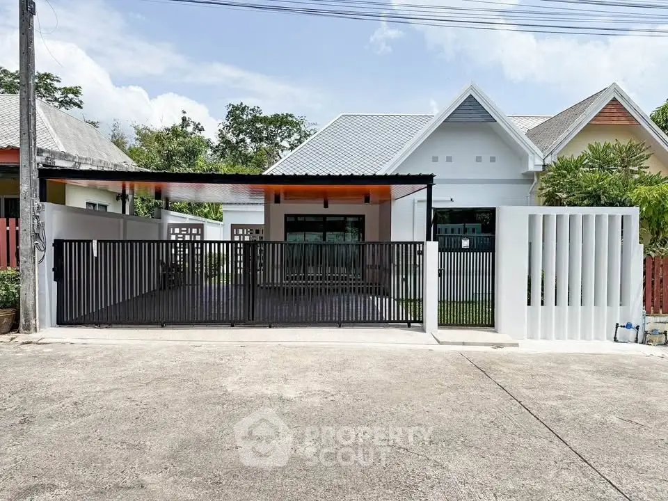 Charming modern house with gated entrance and spacious driveway in a serene neighborhood.