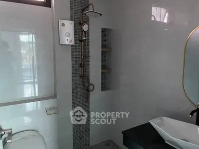 Modern bathroom with sleek shower and stylish fixtures in a contemporary home.