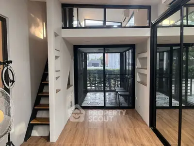 Modern compact living space with mezzanine and large windows