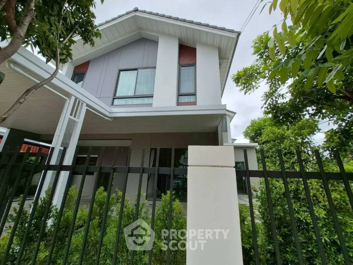 Modern two-story house with sleek design and lush greenery, perfect for family living.