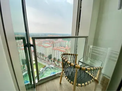 Stunning balcony view overlooking cityscape with cozy seating area, perfect for relaxation.