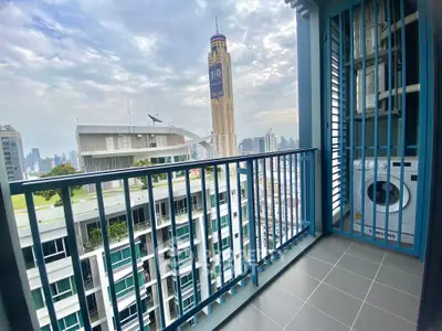 Modern balcony with city view and washing machine in high-rise apartment