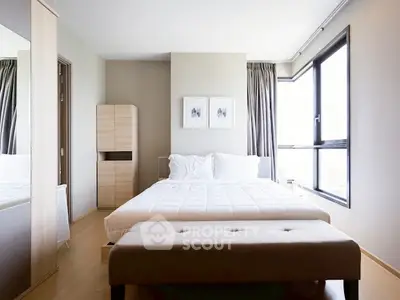 Modern bedroom with large window and minimalist decor in a stylish apartment.