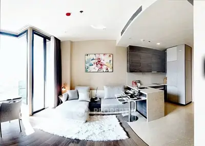 Modern open-layout living room with stylish kitchen and cozy seating area in luxury apartment.