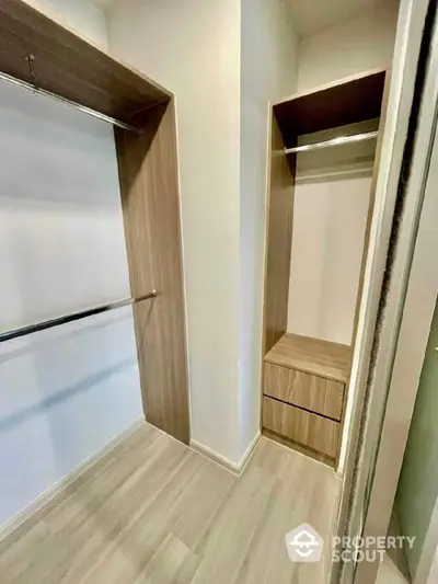 Spacious walk-in closet with modern wooden shelving and ample storage space.