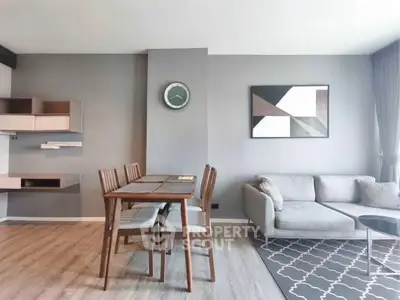 Modern living room with stylish decor and dining area in open layout apartment.