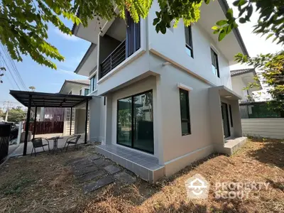 Modern two-story house with spacious garden and large windows