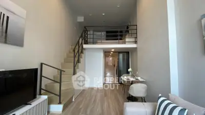 Modern loft apartment with mezzanine, stylish decor, and open living space.