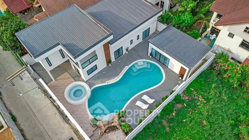 Luxurious modern villa with stunning pool and spacious outdoor area, perfect for relaxation and entertainment.