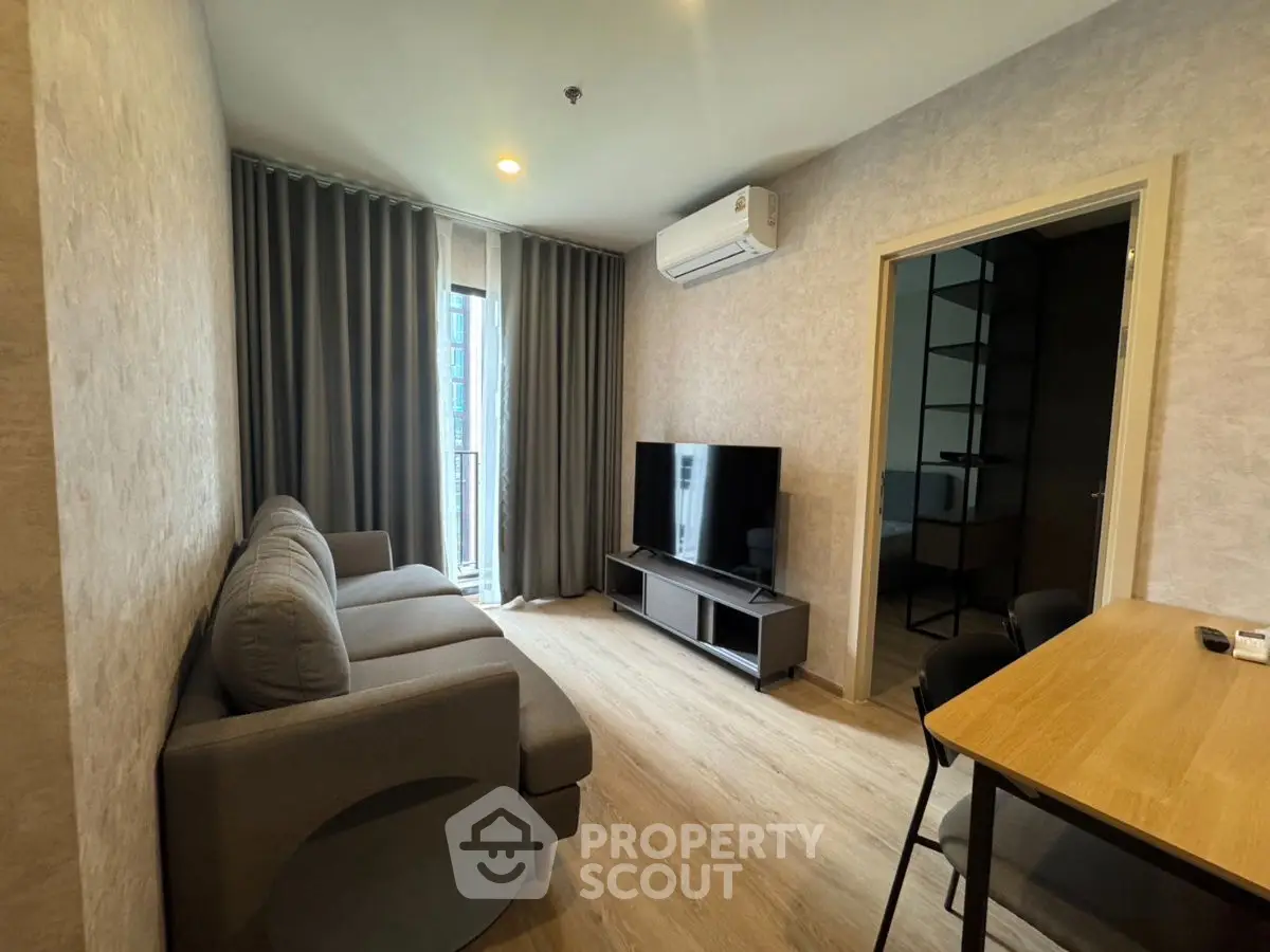 Modern living room with sleek furniture and large TV, perfect for relaxation.