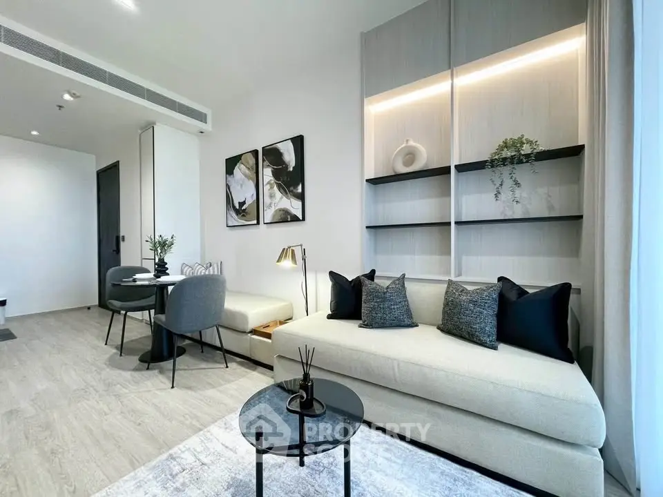 Modern living room with stylish decor and open layout, featuring elegant furniture and natural light.