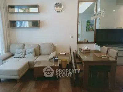 Modern living room with cozy sofa and dining area in open layout apartment.