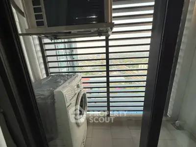 Modern apartment balcony with washing machine and city view