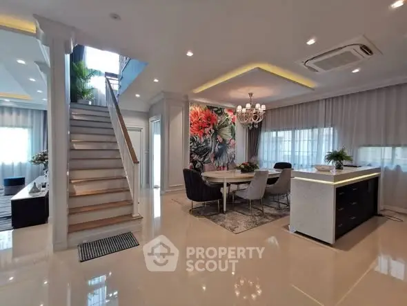Luxurious open-plan living room with elegant staircase and modern decor
