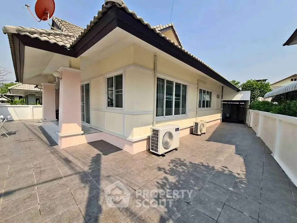 Charming single-story home with spacious outdoor area and modern roof design.