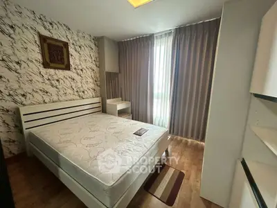Cozy bedroom with modern decor and large window for natural light