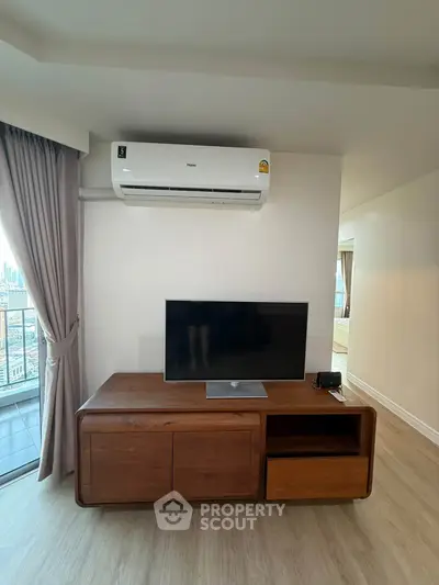 Modern living room with air conditioning and balcony view in a stylish apartment.