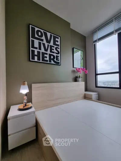 Modern bedroom with stylish decor and city view, featuring a cozy bed and elegant nightstand.
