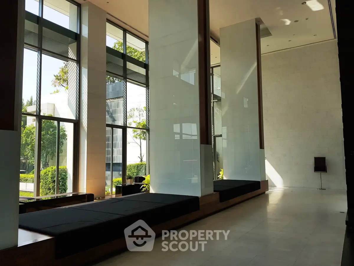 Modern building entrance with tall glass windows and sleek design